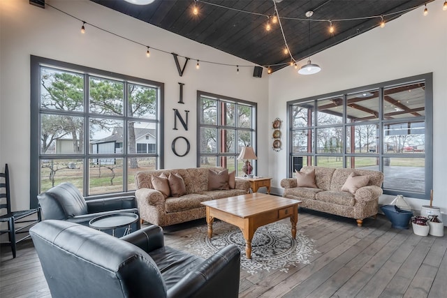 interior space featuring vaulted ceiling, wooden ceiling, and rail lighting