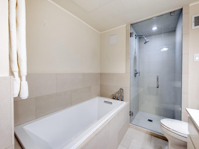 3525 Turtle Creek Blvd Unit 3D, Dallas, TX 75219 - full bathroom featuring toilet, a shower stall, a bath, tile patterned floors, and vanity