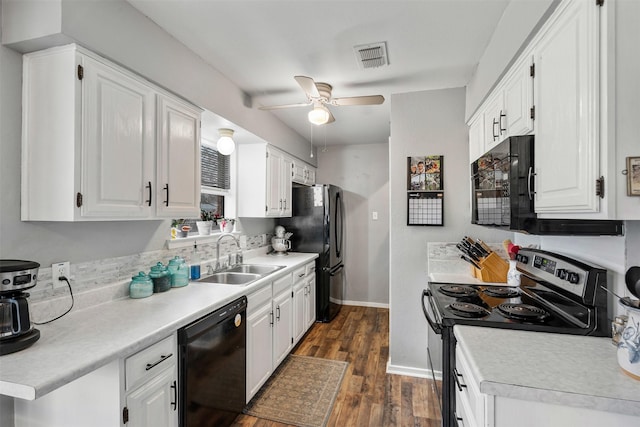 kitchen with black appliances, white cabinetry, dark wood-style flooring, and a sink