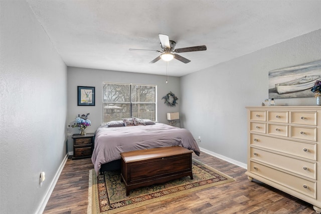 bedroom featuring a ceiling fan, baseboards, and wood finished floors