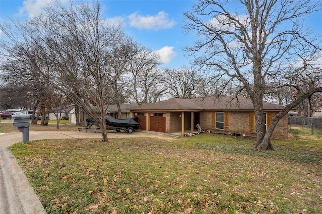 ranch-style home with a front lawn, brick siding, driveway, and an attached garage