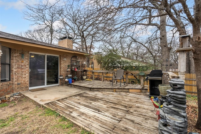 wooden deck featuring a grill