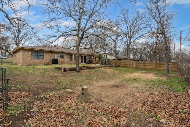 view of yard featuring a vegetable garden, central AC, and fence