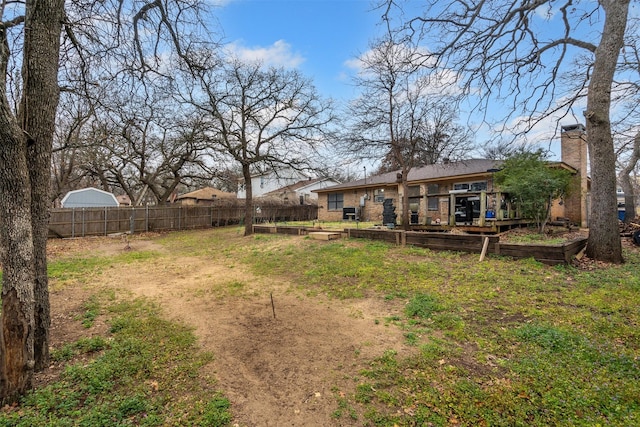 view of yard with a vegetable garden and fence