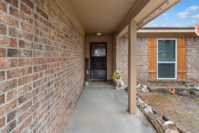 property entrance featuring brick siding