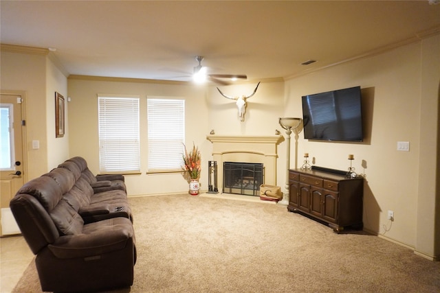 living area featuring a fireplace, carpet flooring, visible vents, a ceiling fan, and ornamental molding