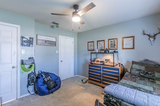 carpeted bedroom with ceiling fan, visible vents, and baseboards