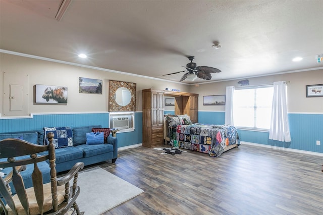 living room featuring crown molding, wainscoting, ceiling fan, wood finished floors, and cooling unit