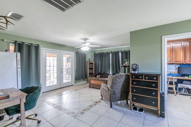 office featuring light tile patterned floors, visible vents, a ceiling fan, and french doors