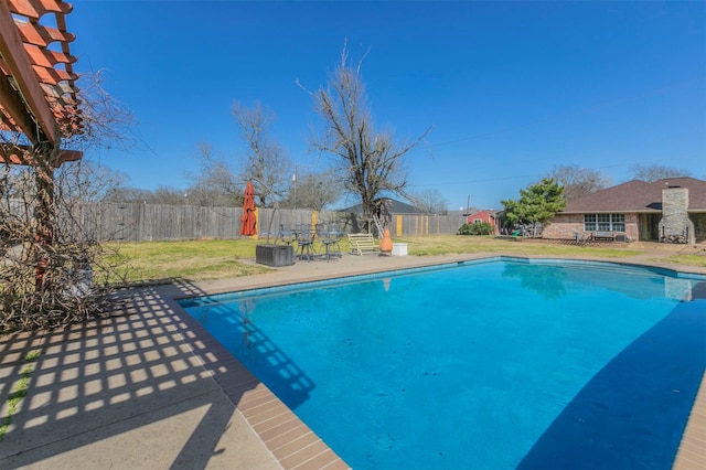 view of swimming pool featuring a fenced in pool, a fenced backyard, a lawn, and a patio