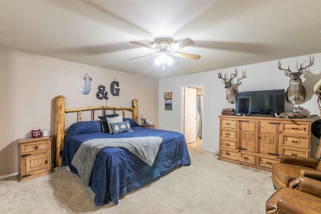 bedroom featuring light carpet and a ceiling fan