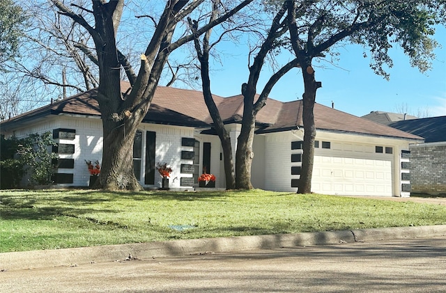 single story home with brick siding, a garage, and a front lawn