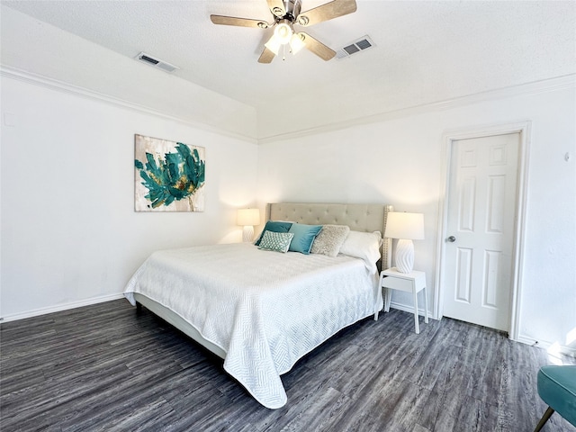 bedroom with visible vents, baseboards, and wood finished floors