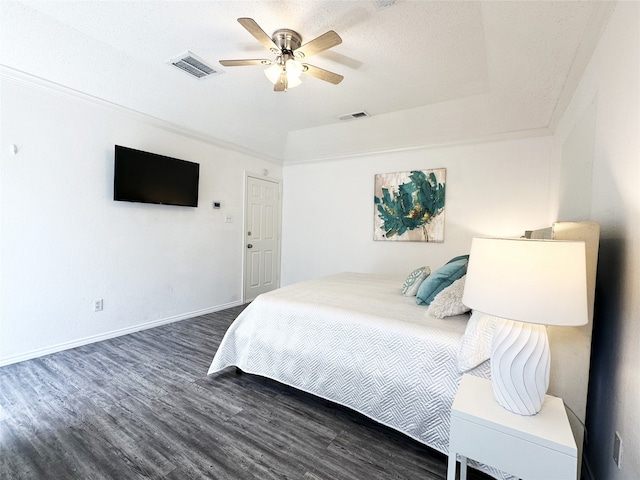 bedroom with visible vents, a ceiling fan, baseboards, and wood finished floors