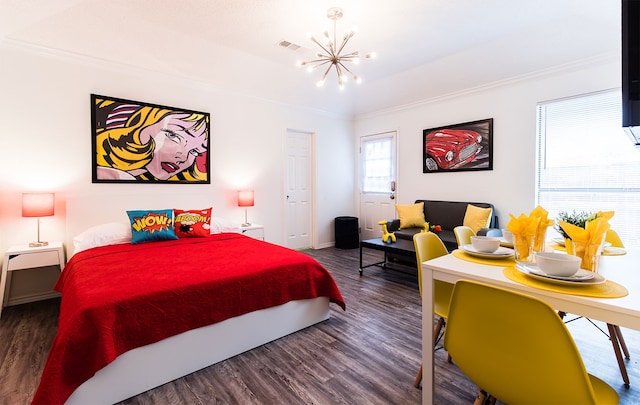 bedroom featuring visible vents, baseboards, wood finished floors, crown molding, and a notable chandelier