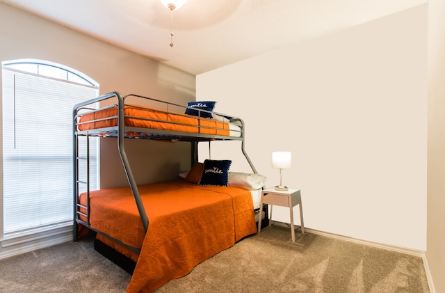 bedroom with carpet floors and baseboards
