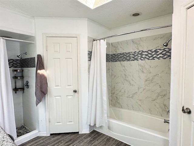 full bathroom featuring shower / bath combination with curtain, a textured ceiling, and wood finished floors