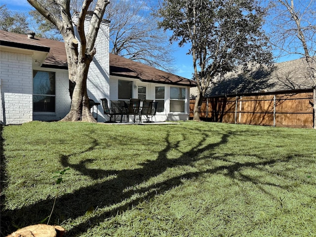 view of yard featuring fence and a patio