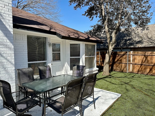 view of patio / terrace featuring fence and outdoor dining space