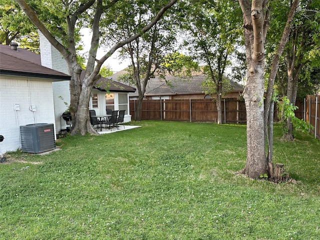 view of yard with central air condition unit, a patio, and a fenced backyard