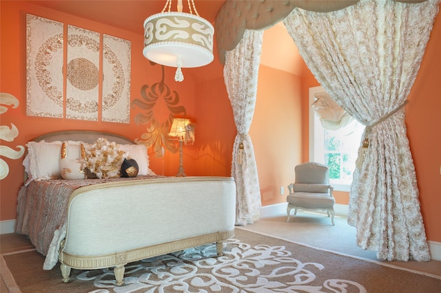 bedroom featuring baseboards and carpet floors