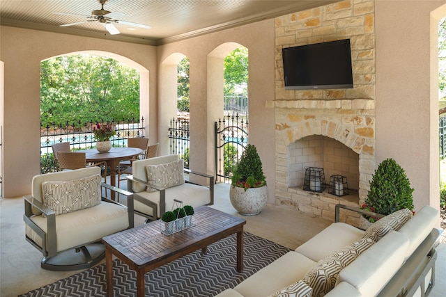 view of patio / terrace with an outdoor living space with a fireplace, ceiling fan, and fence