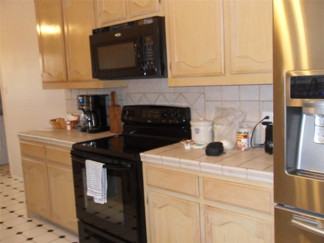 kitchen featuring backsplash, black appliances, and light brown cabinetry