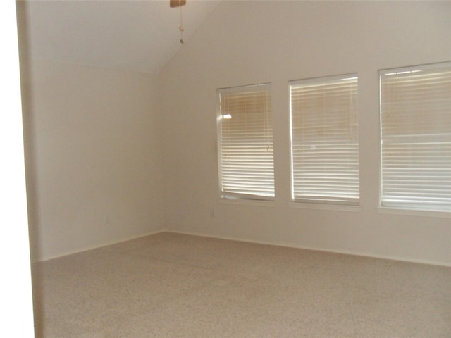 unfurnished room with vaulted ceiling, carpet, and a ceiling fan