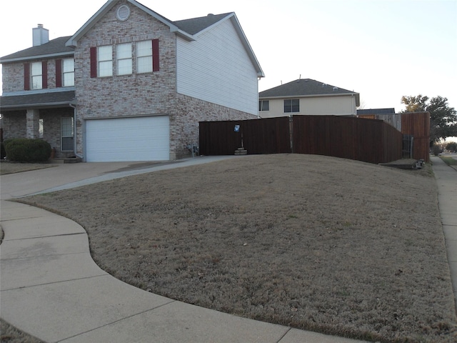 view of side of home featuring an attached garage, fence, concrete driveway, and brick siding