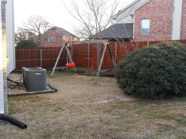 view of play area featuring a fenced backyard and central air condition unit