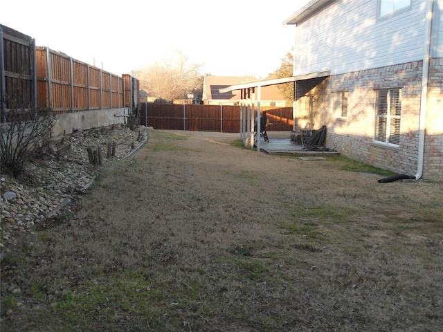 view of yard with a fenced backyard and a patio