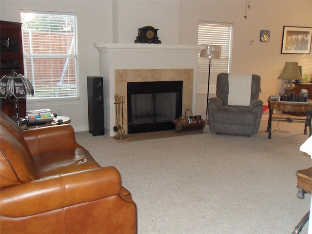 carpeted living room with a fireplace with flush hearth