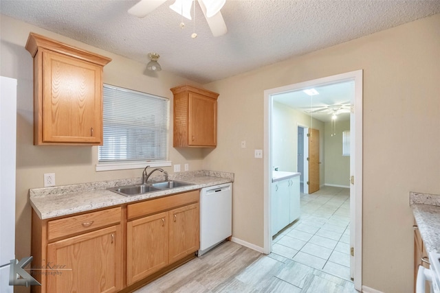 kitchen with dishwasher, light countertops, ceiling fan, and a sink