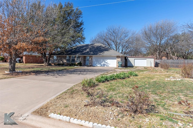 ranch-style house featuring driveway, a front yard, fence, and brick siding