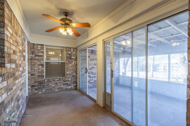 unfurnished sunroom featuring ceiling fan