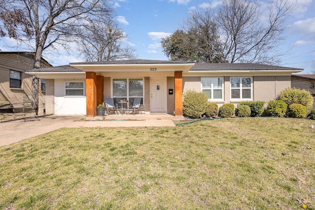 single story home with brick siding and a front yard