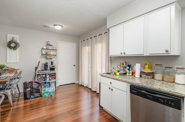 kitchen with white cabinets, dishwasher, dark wood-type flooring, light stone countertops, and a textured ceiling