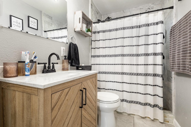 full bathroom with a textured wall, toilet, vanity, a shower with curtain, and tile patterned floors