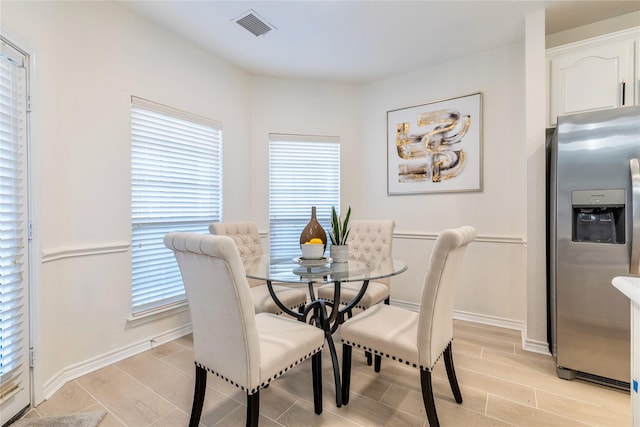 dining area featuring wood tiled floors and baseboards