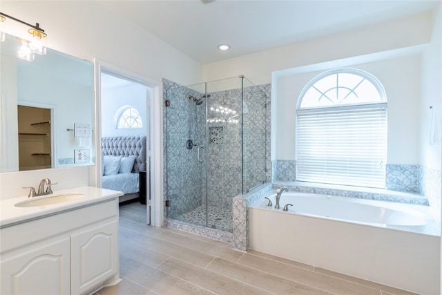 full bathroom with a shower stall, a bath, vanity, ensuite bathroom, and wood finish floors