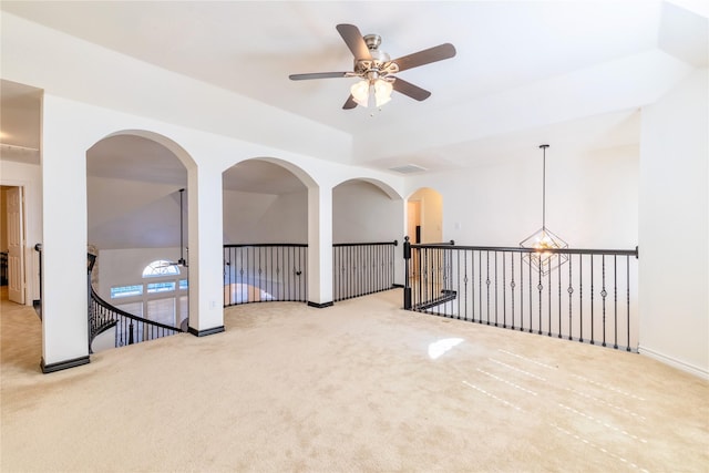 spare room featuring ceiling fan, carpet flooring, and baseboards