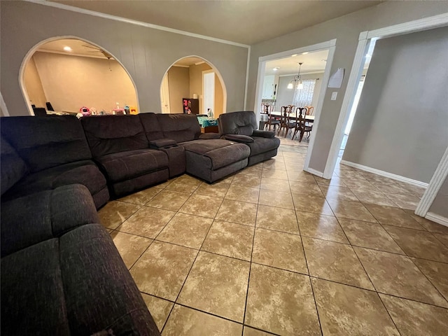 tiled living room with baseboards and ornamental molding