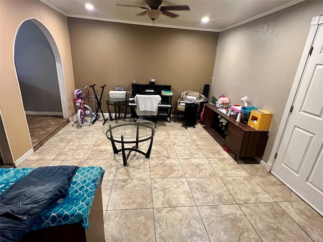 home office with light tile patterned floors, ceiling fan, arched walkways, and crown molding