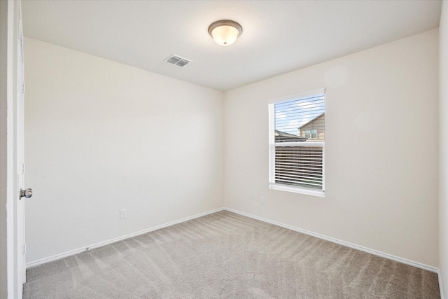 carpeted spare room with baseboards and visible vents