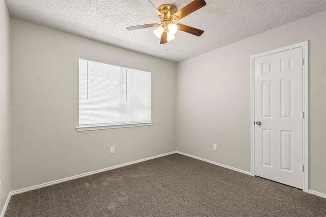 unfurnished room featuring dark colored carpet, ceiling fan, a textured ceiling, and baseboards