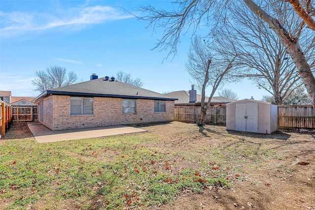 back of property featuring a patio, a fenced backyard, a storage unit, an outdoor structure, and brick siding