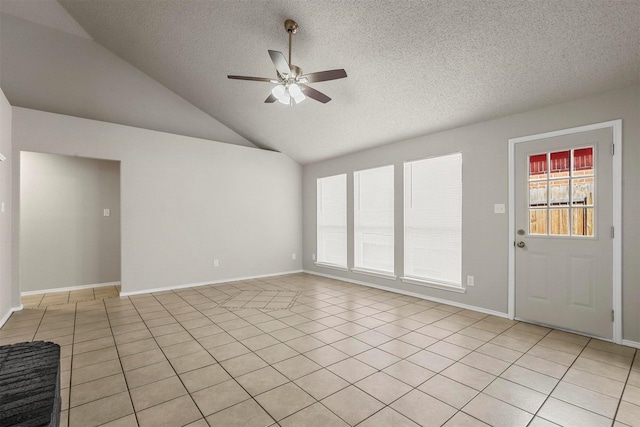 interior space with lofted ceiling, a textured ceiling, and a ceiling fan