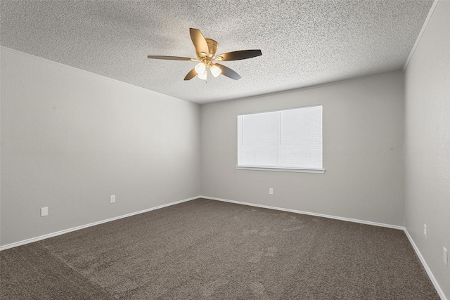 empty room with crown molding, dark carpet, ceiling fan, a textured ceiling, and baseboards