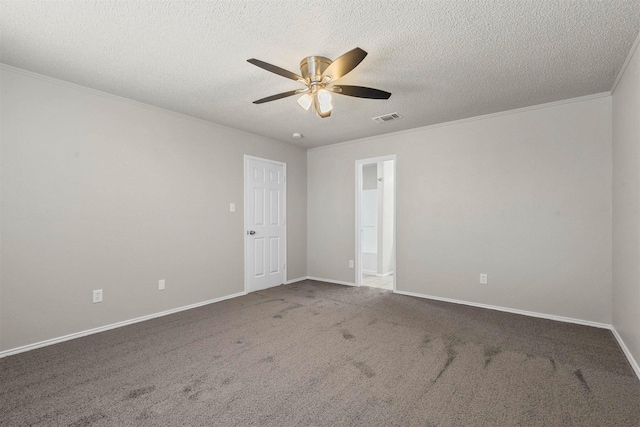 carpeted empty room with baseboards, visible vents, a ceiling fan, and crown molding