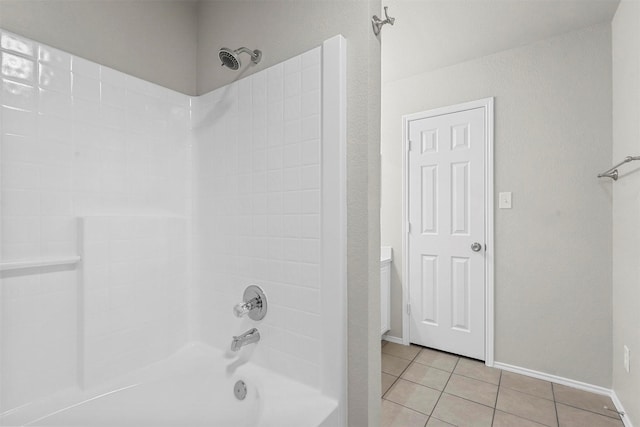 bathroom featuring  shower combination, tile patterned flooring, and baseboards